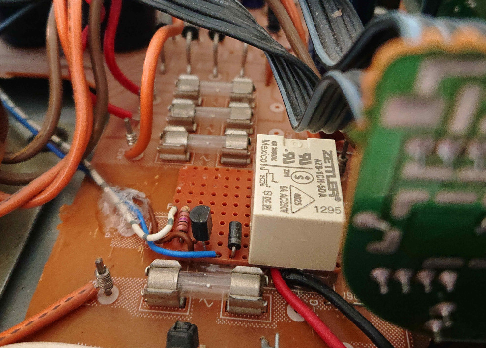 Picture of a transistor and relay on a PCB, switching power to an amplifier.